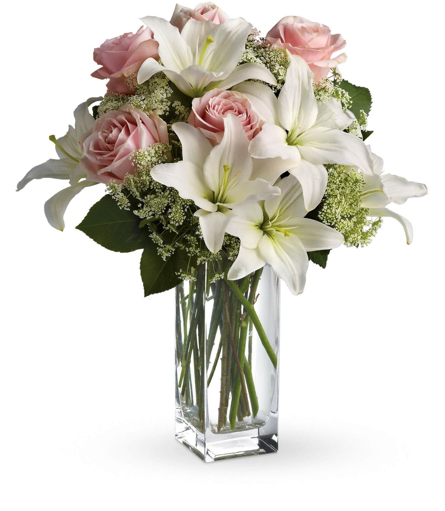 The TF Heavenly and Harmony Bouquet features fresh white Asiatic lilies, pink roses, and delicate white filler flowers with green leaves, arranged in a clear glass vase for an elegant touch.