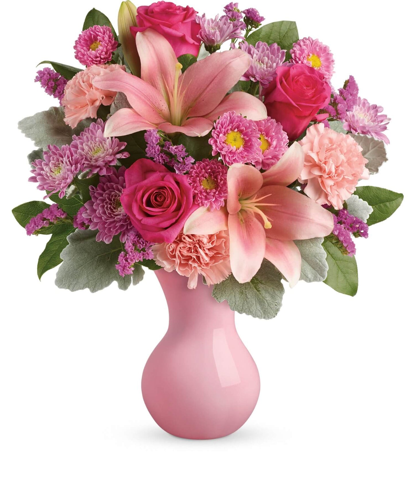 TF's Lush Blush Bouquet features pink lilies, roses, carnations, and chrysanthemums with lush green leaves in a glossy Serendipity vase, showcasing beautiful shades of pink and purple.