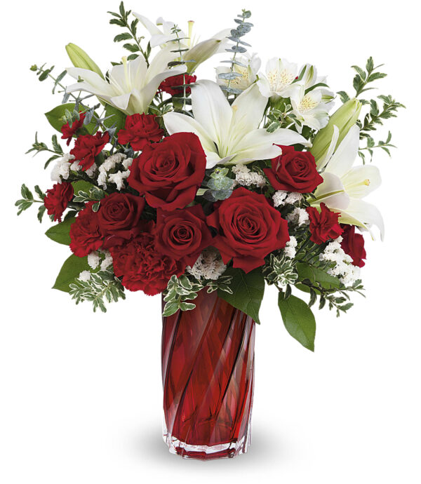 The Swirling Love Bouquet by Fleuriste Terrafolia Flowers features red roses, red carnations, white lilies, and greenery artfully arranged in the Swirling Splendor Vase—an unforgettable Valentines gift.