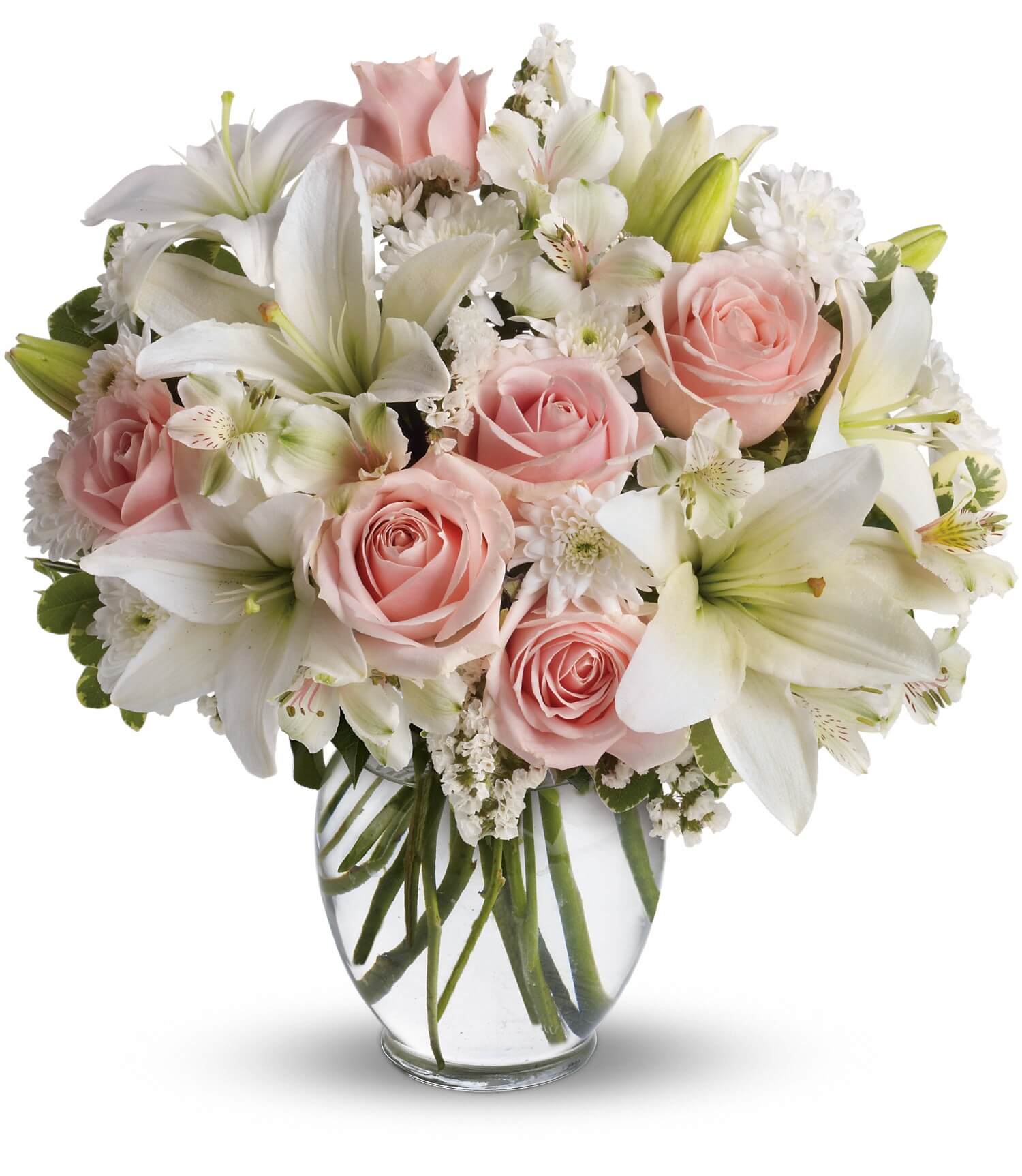 The TF Arrive In Style Bouquet features a rounded, elegant display of light pink roses, white asiatic lilies, assorted white flowers, and green foliage in a clear flower vase.