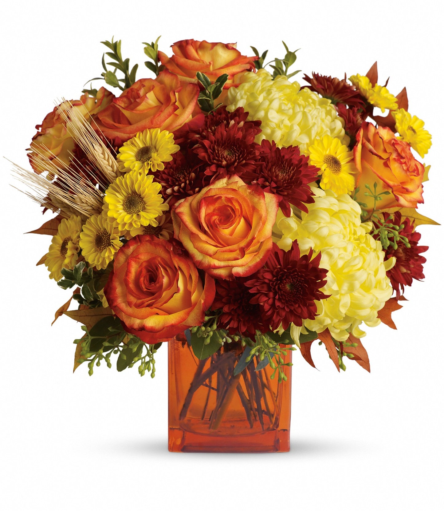 Autumn Expression by TF is a vibrant contemporary flower arrangement in an orange vase featuring orange roses, yellow chrysanthemums, burgundy mums, yellow daisies, wheat stalks, and lush green foliage.