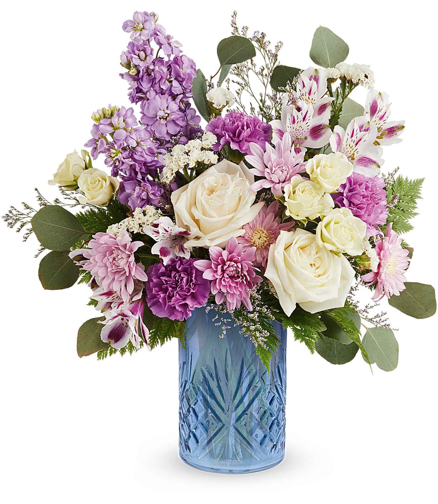 The Blue Bliss Bouquet features white roses, pink carnations, lavender, greenery, and small white blossoms stylishly arranged in a striking Blue Belle Vase.