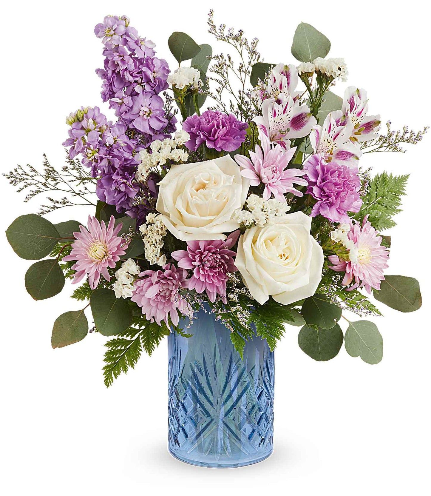 The Blue Bliss Bouquet features white roses, pink carnations, lavender, greenery, and small white blossoms stylishly arranged in a striking Blue Belle Vase.