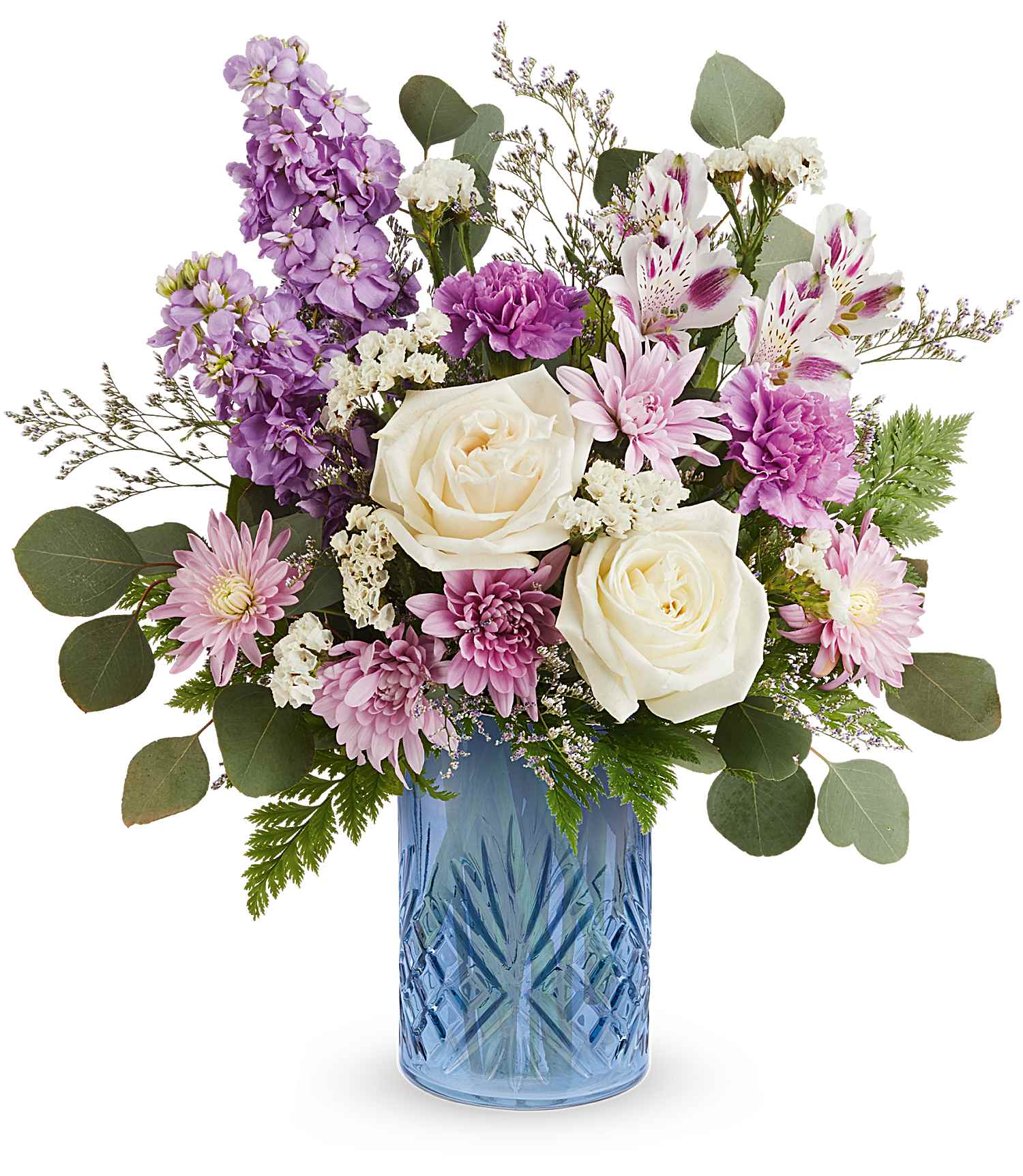 The Blue Bliss Bouquet features white roses, pink carnations, lavender, greenery, and small white blossoms stylishly arranged in a striking Blue Belle Vase.