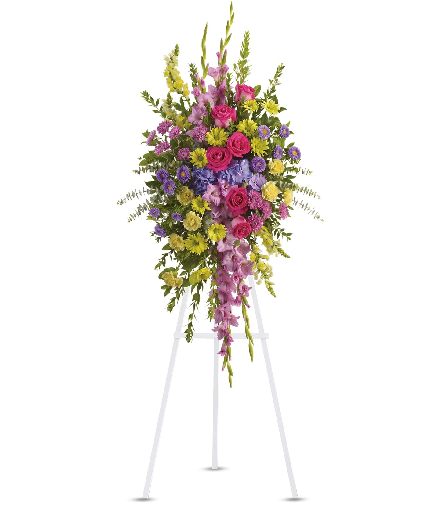 The TF Bright and Beautiful Spray is a large, colorful funeral arrangement with pink roses, purple lisianthus, yellow and lavender flowers, accented with greenery and displayed on a white easel against a plain background.