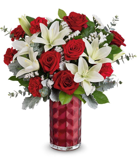 The Floral Harmony Bouquet by Fleuriste Terrafolia Flowers features red roses, white asiatic lilies, red carnations, filler flowers, and greenery in a tall Love Prism Vase.