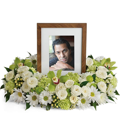 The TF Garden Wreath frames a black and white photo of a smiling elderly man in a hat, surrounded by luxurious white daisies, green carnations, chrysanthemums, and assorted greenery.