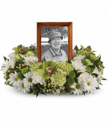 The TF Garden Wreath frames a black and white photo of a smiling elderly man in a hat, surrounded by luxurious white daisies, green carnations, chrysanthemums, and assorted greenery.