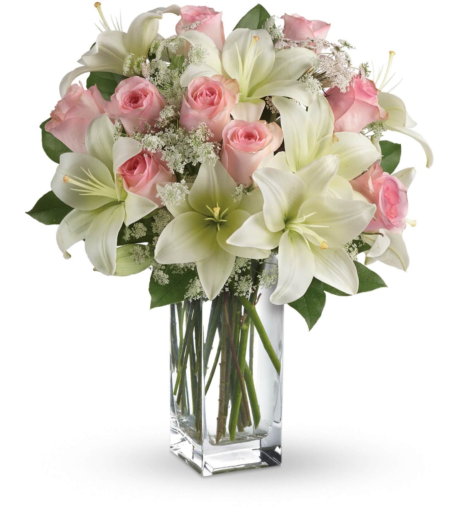 The TF Heavenly and Harmony Bouquet features fresh white Asiatic lilies, pink roses, and delicate white filler flowers with green leaves, arranged in a clear glass vase for an elegant touch.