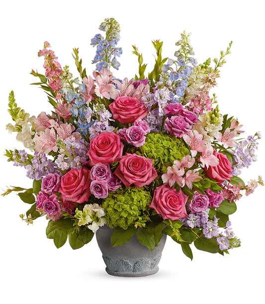 The Keep Blooming Bouquet features pink roses, pastel purple and blue flowers, green hydrangea, and lush greenery in a decorative Parisian Garden Pot, beautifully arranged for a stunning display.