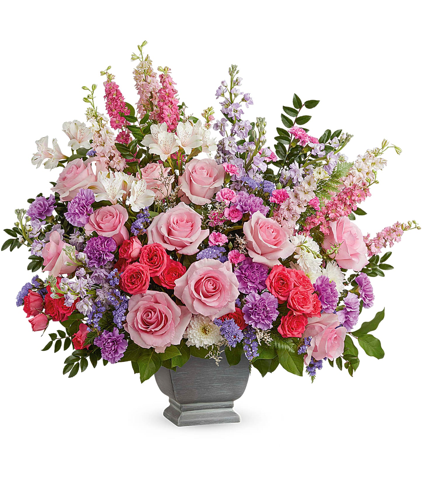 The Love and Light Bouquet in Teleflora's Modern Heritage Pot features pink roses, lavender carnations, purple and white flowers, greenery, and a mix of soft pastel blooms arranged beautifully.