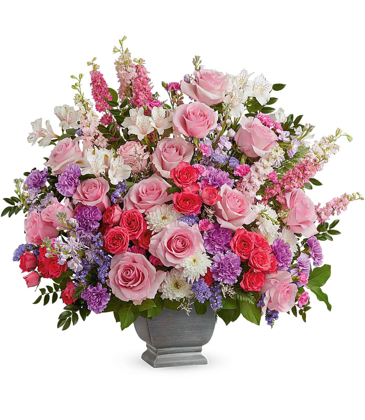 The Love and Light Bouquet in Teleflora's Modern Heritage Pot features pink roses, lavender carnations, purple and white flowers, greenery, and a mix of soft pastel blooms arranged beautifully.