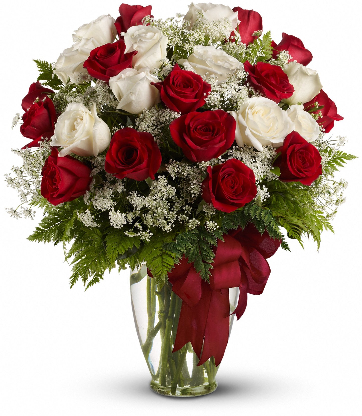 Love's Divine by TF features a clear glass vase with red and white roses, lush greenery, delicate white fillers, and a bold red ribbon—ready for delivery to your loved one.
