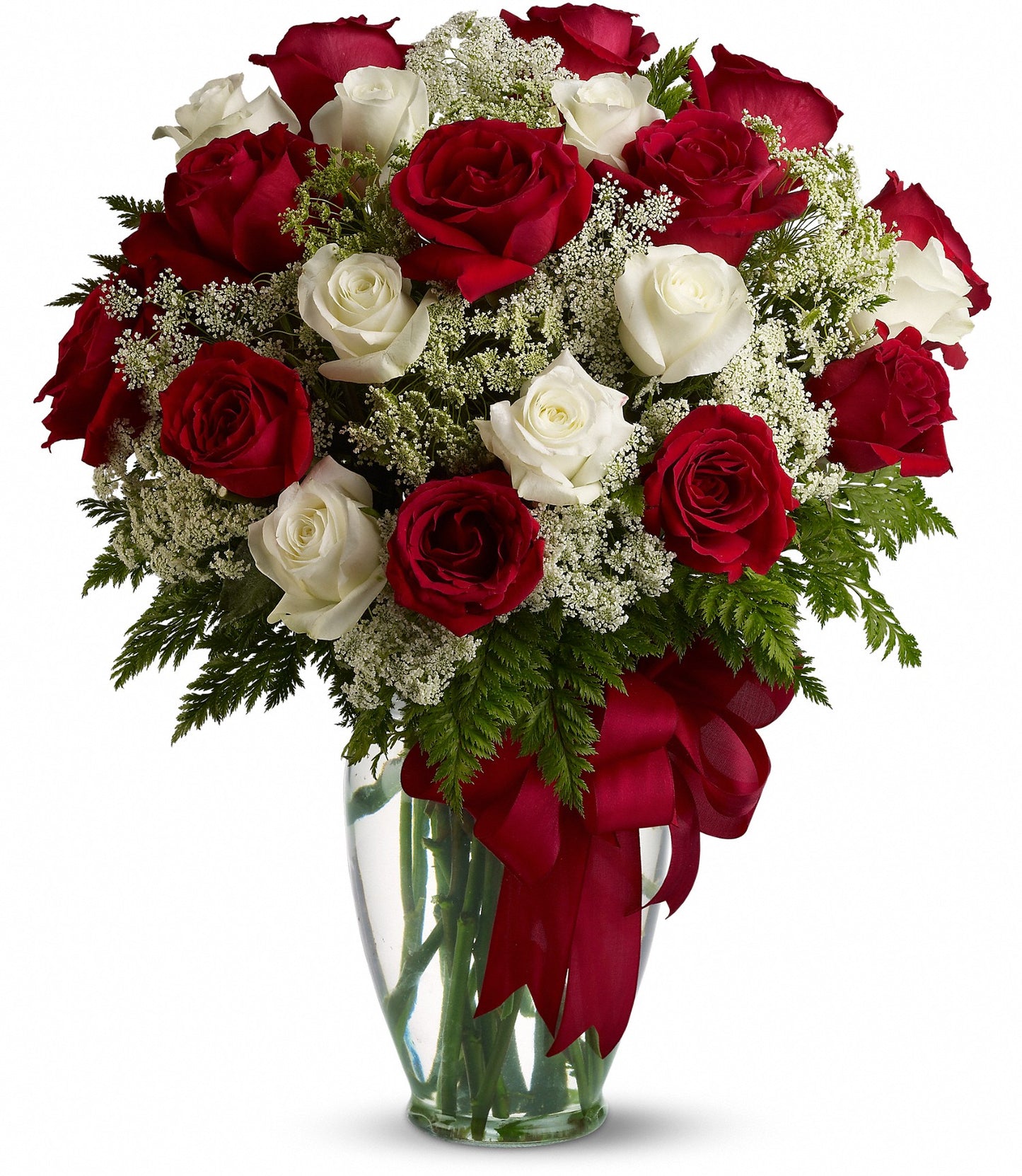 Love's Divine by TF features a clear glass vase with red and white roses, lush greenery, delicate white fillers, and a bold red ribbon—ready for delivery to your loved one.