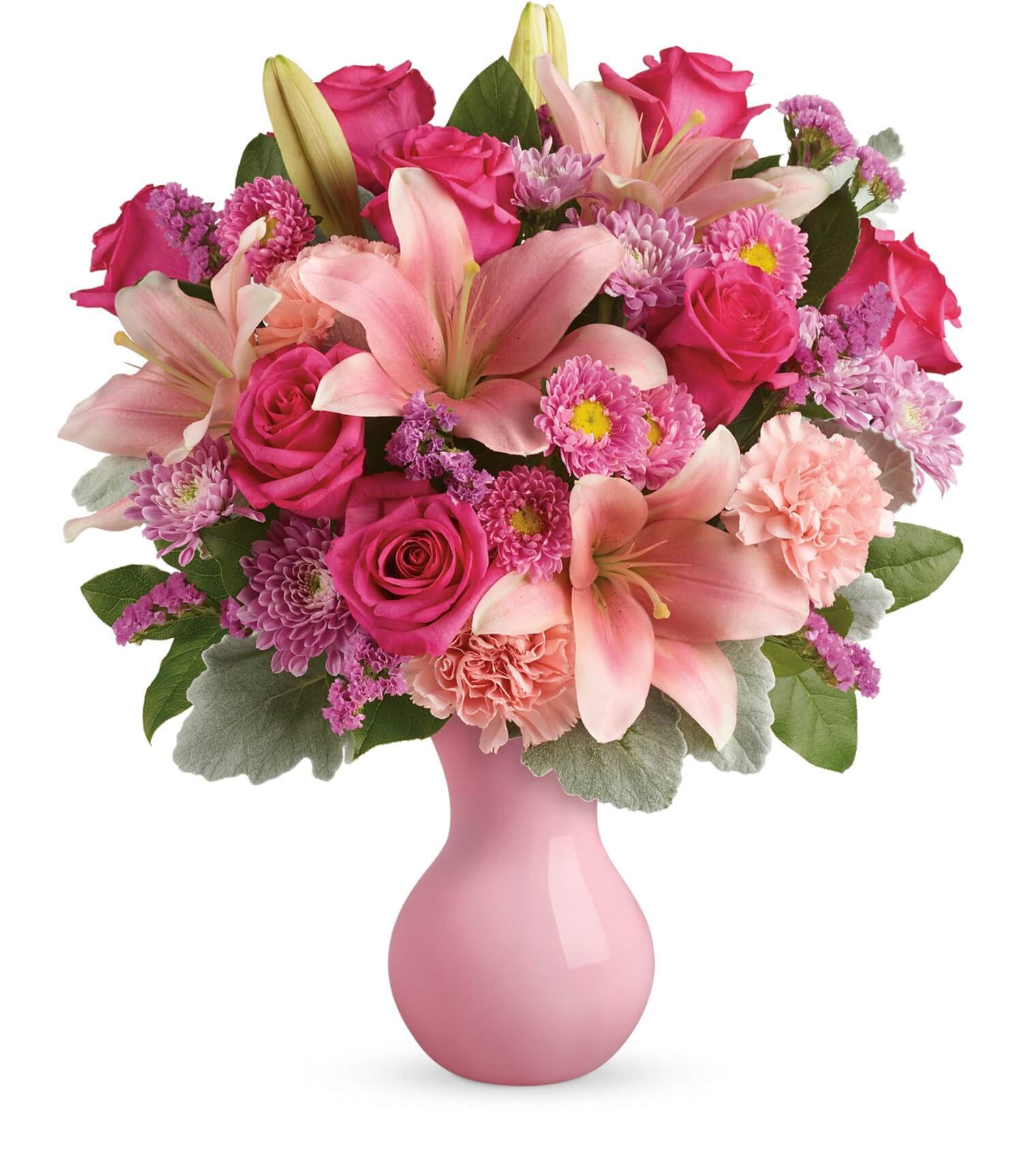 TF's Lush Blush Bouquet features pink lilies, roses, carnations, and chrysanthemums with lush green leaves in a glossy Serendipity vase, showcasing beautiful shades of pink and purple.