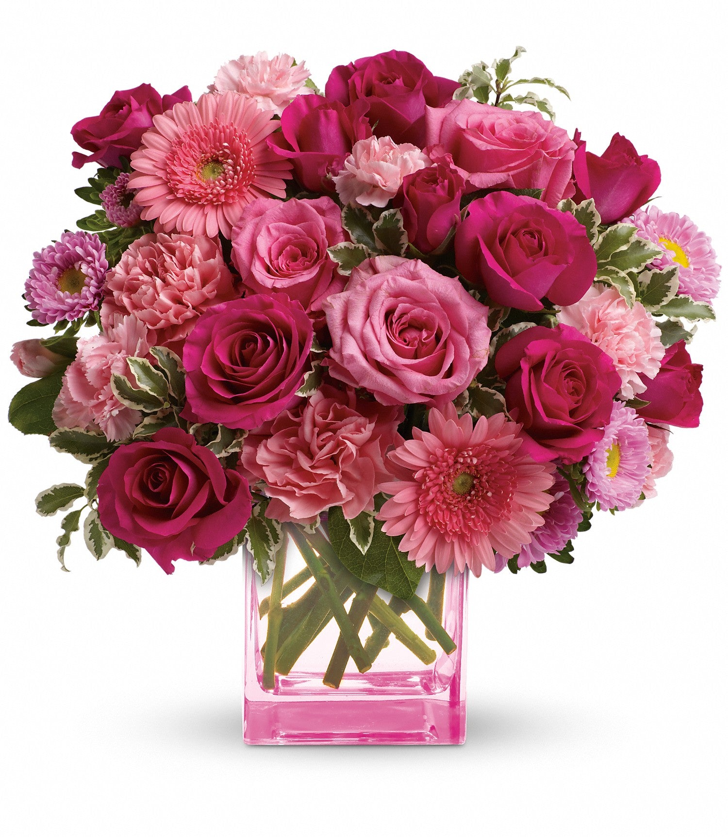 Mary Kay's Pink Dreams Bouquet features a pink Cube vase filled with pink roses, carnations, gerbera daisies, and assorted greenery, arranged beautifully on a white background.