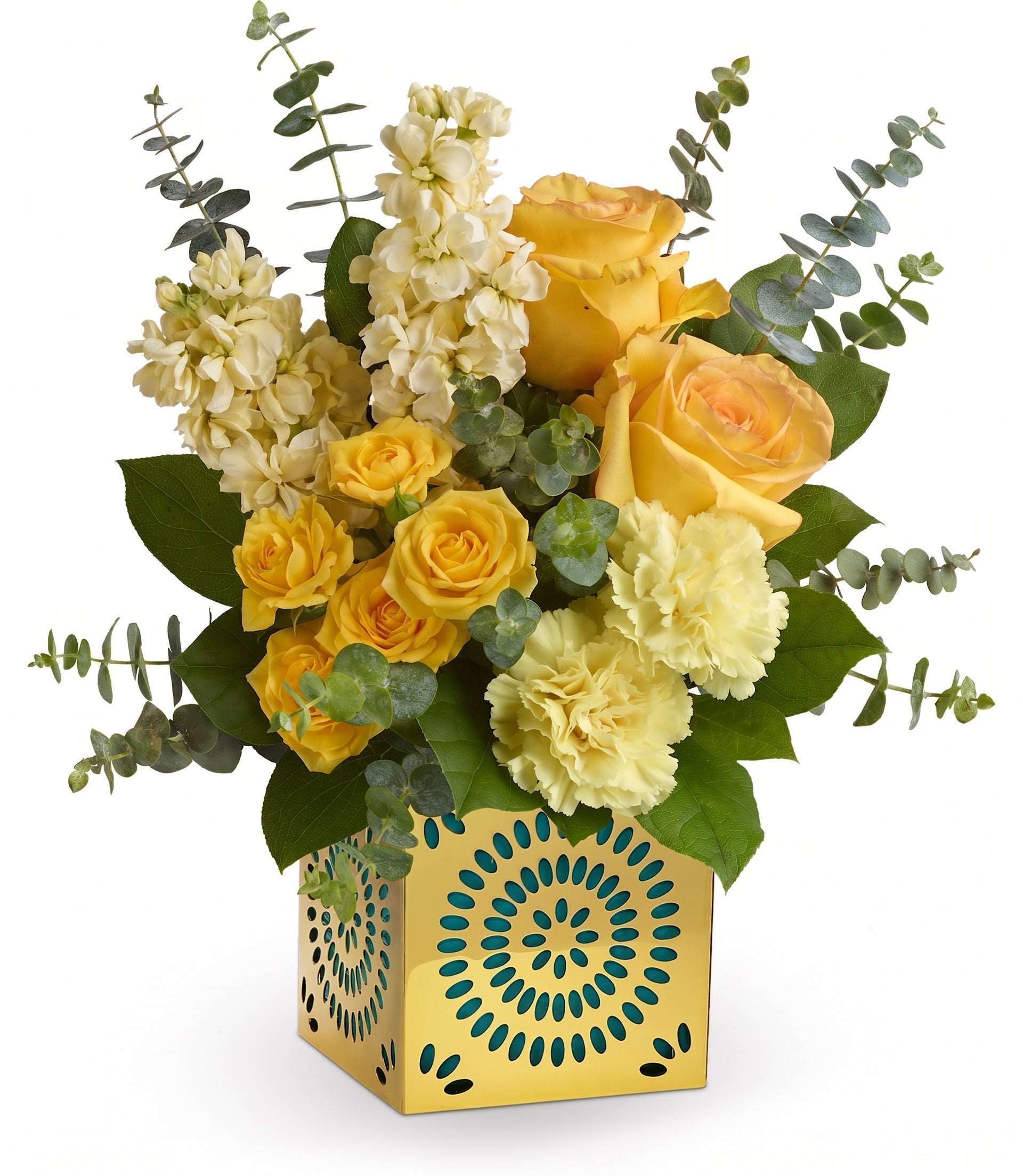 The Shimmer Of Thanks Bouquet features yellow roses, yellow carnations, and stock with eucalyptus in a Celebrate in Style cube—a yellow vase with blue and green geometric patterns.