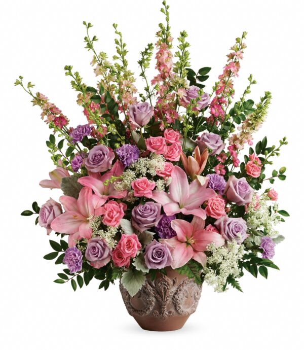 The Soft Blush Bouquet by Fleuriste Terrafolia Flowers features a large ornate vase filled with pink asiatic lilies, lavender and pink roses, Queen Anne’s lace, and lush greenery in an elegant display.