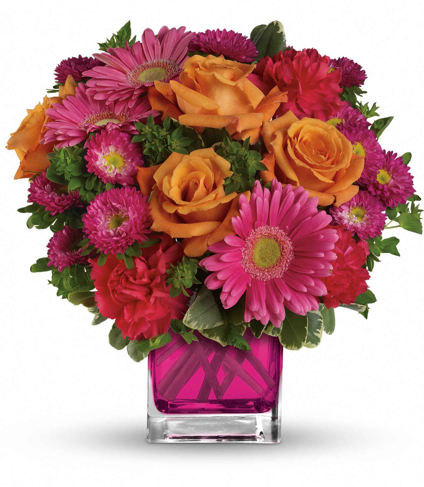 The Turn Up The Pink Bouquet features orange roses and hot pink gerberas with green foliage, all arranged in a stylish square pink glass vase.