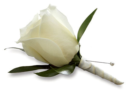 The TF White Rose Boutonniere features a single white rose with lush greens, wrapped in satin ribbon and secured with a pearl-headed pin, displayed on a white surface.
